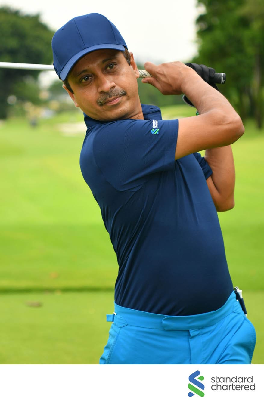 A man in a blue shirt and blue shorts is swinging a golf club. AI generated content