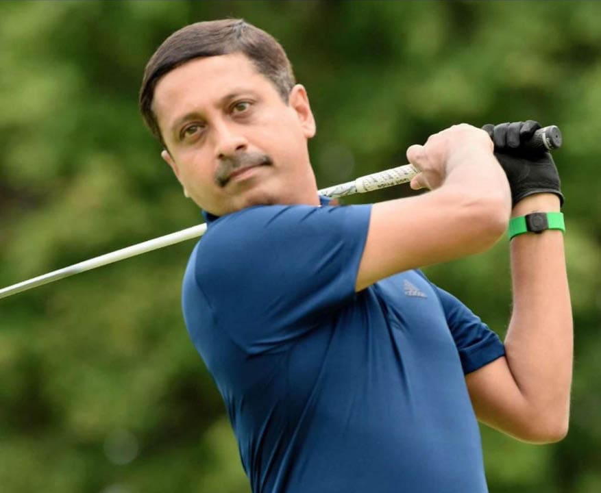 A man in a blue shirt is holding a golf club and swinging it. AI generated content