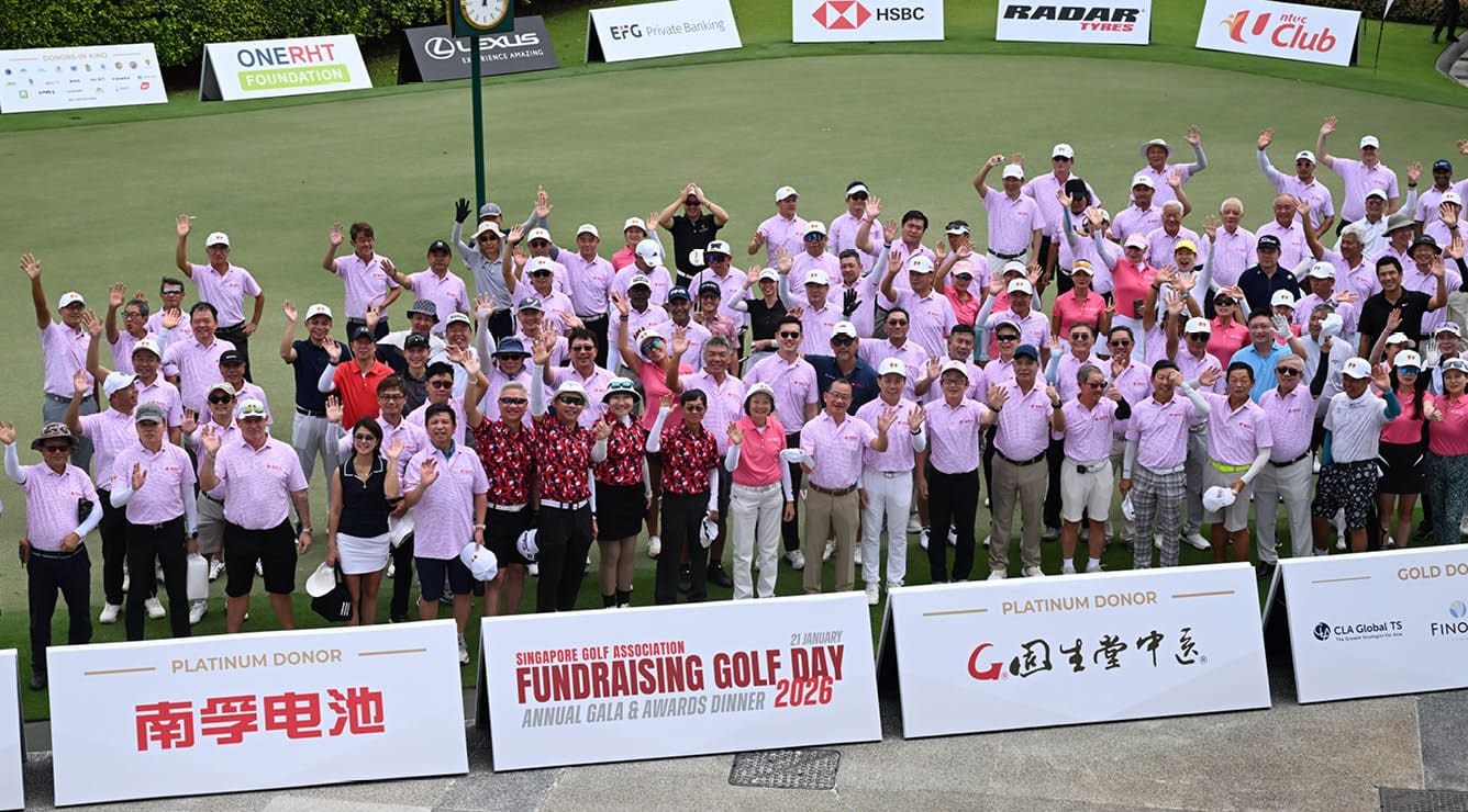 A large group of people wearing pink shirts are standing on a golf course. AI generated content