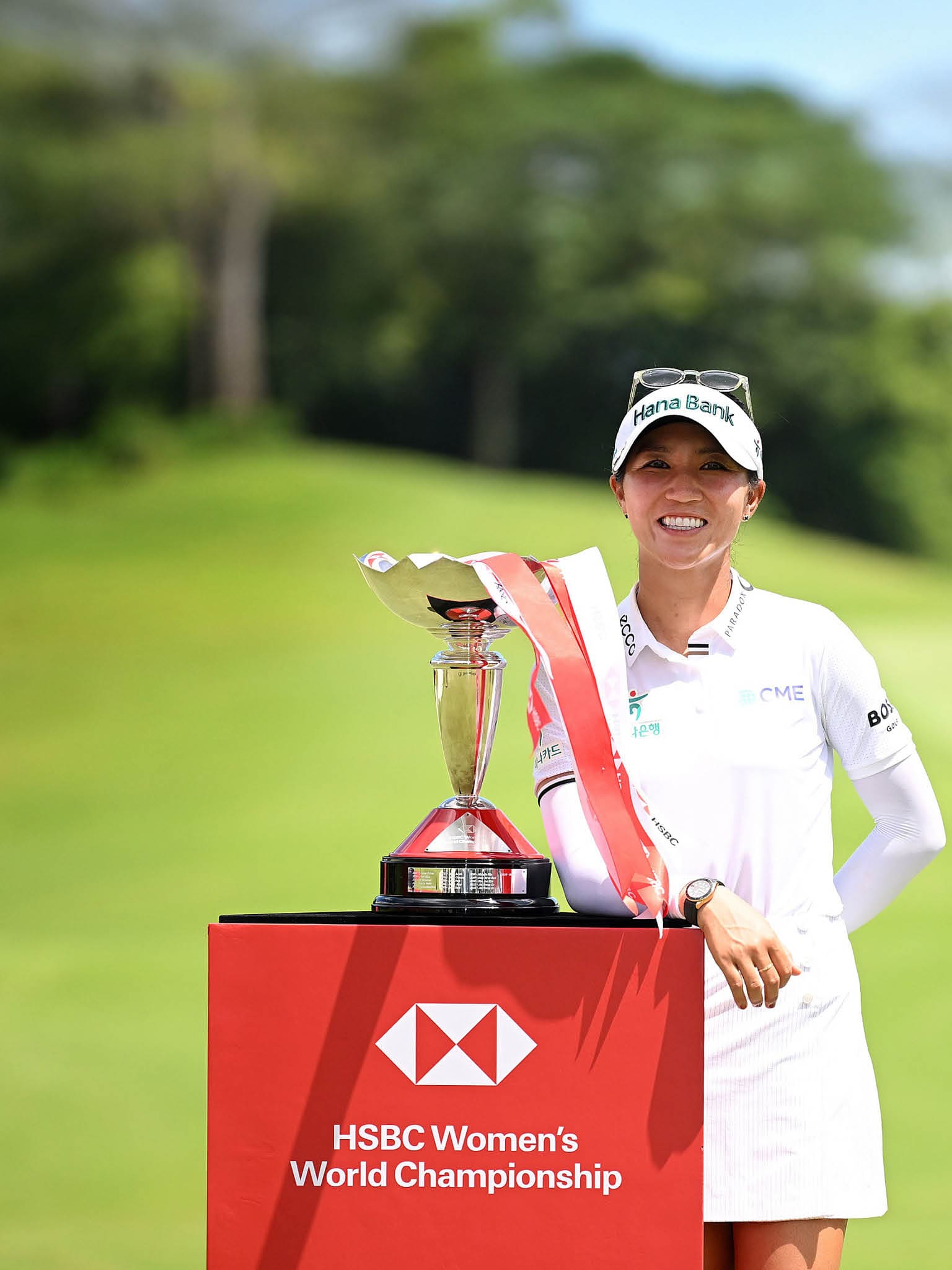 A woman is holding a trophy on a green field. AI generated content