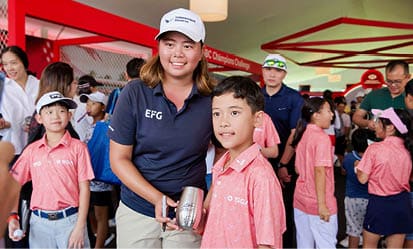 A woman in a blue shirt and white hat is holding a cup. AI generated content