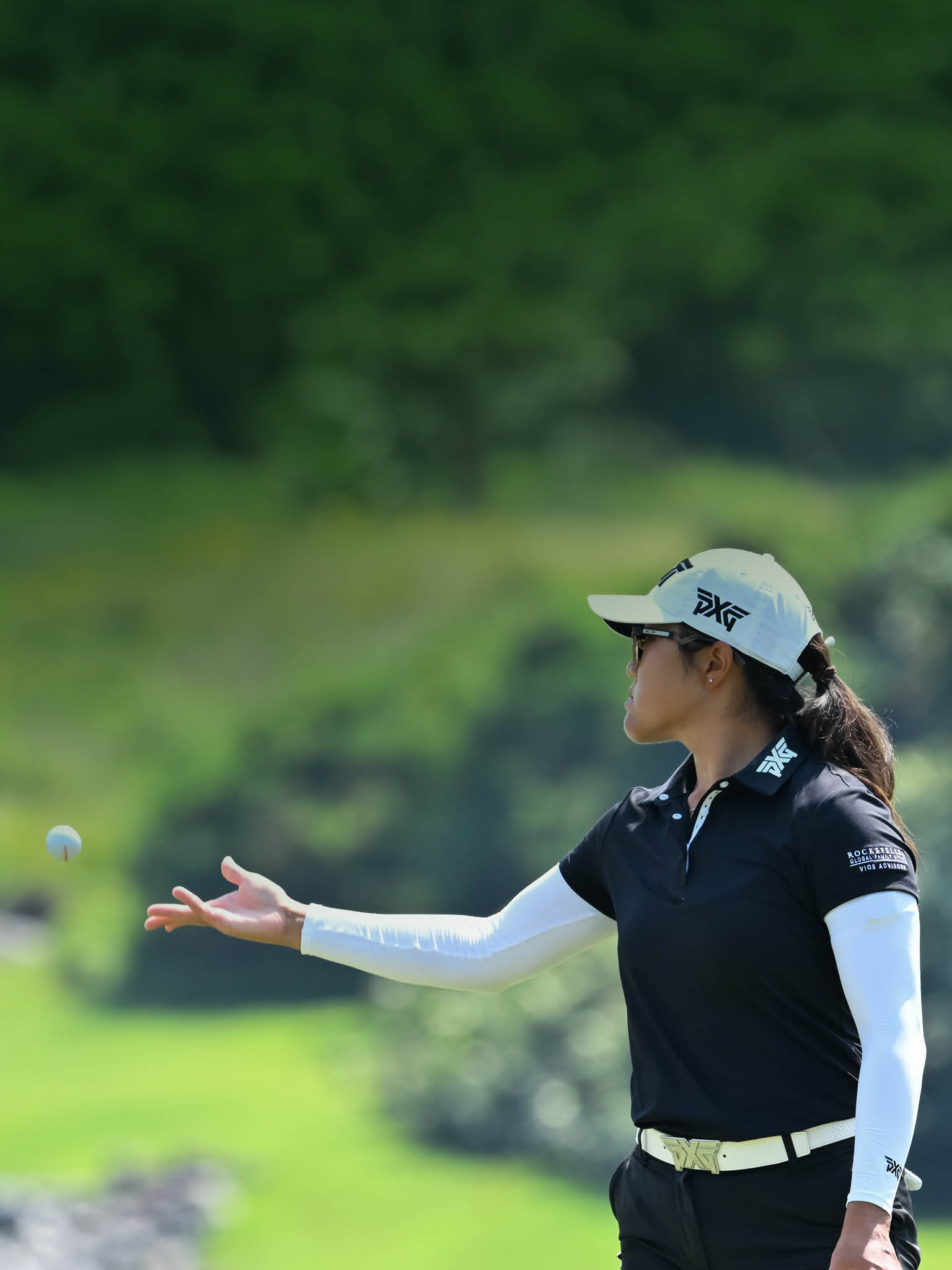 A woman in a black shirt and white hat is playing golf. AI generated content